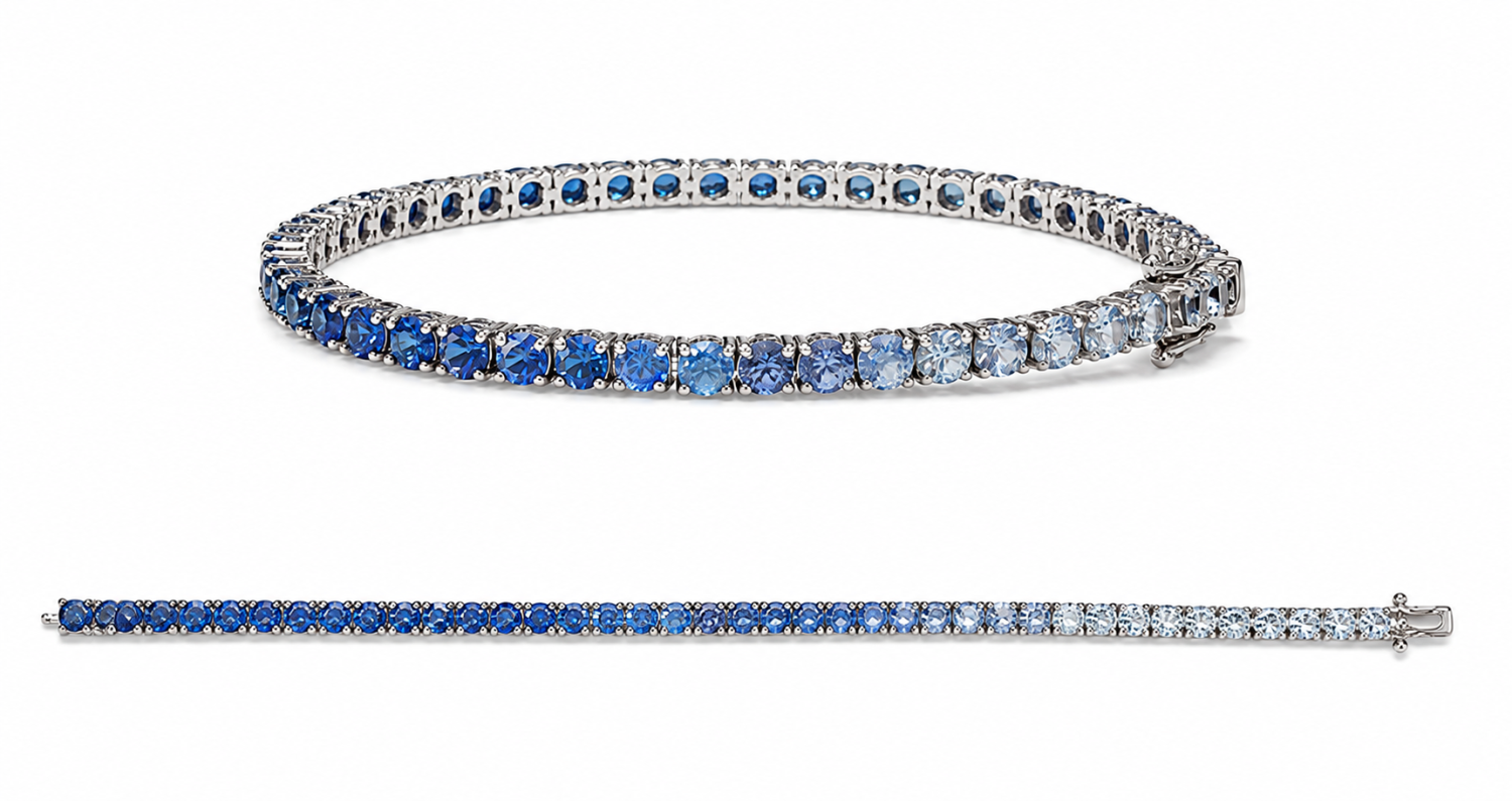 Blue sapphire ombre tennis bracelet in 18k gold shown clasped and laid straight