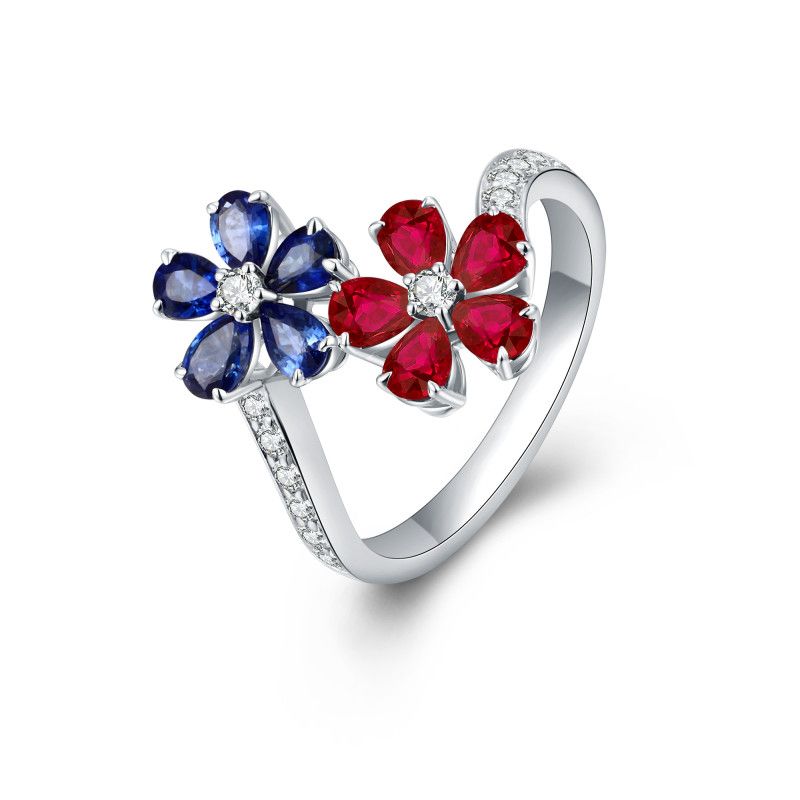 Blue sapphire and red ruby twin flowers with natural diamond centres and diamond-set shoulders in an 18k white gold ring