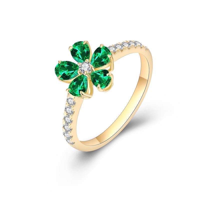 Five pear-cut emeralds surrounding a natural diamond centre with diamond-set shoulders in an 18k yellow gold ring