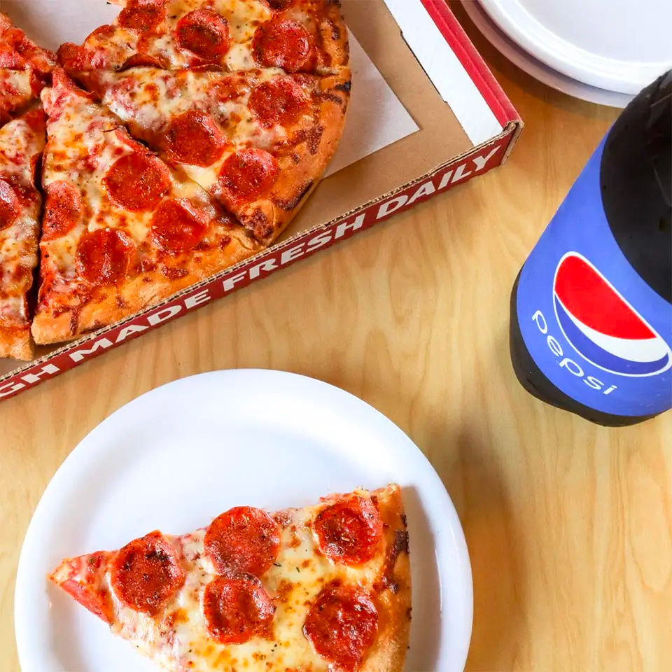 Pepperoni Pizza on a Table with Pepsi | Westside Pizza