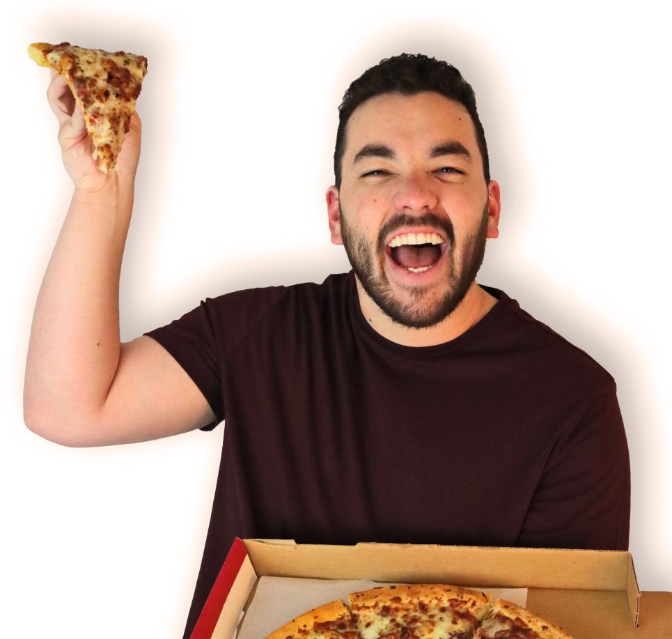 Person eating pizza with a white backdrop | Westside Pizza