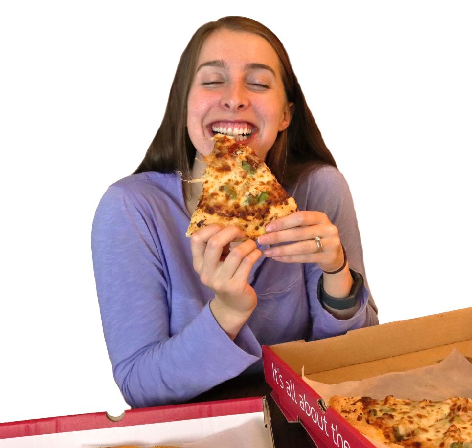 Young woman eating pizza in front of a white backdrop | Westside Pizza