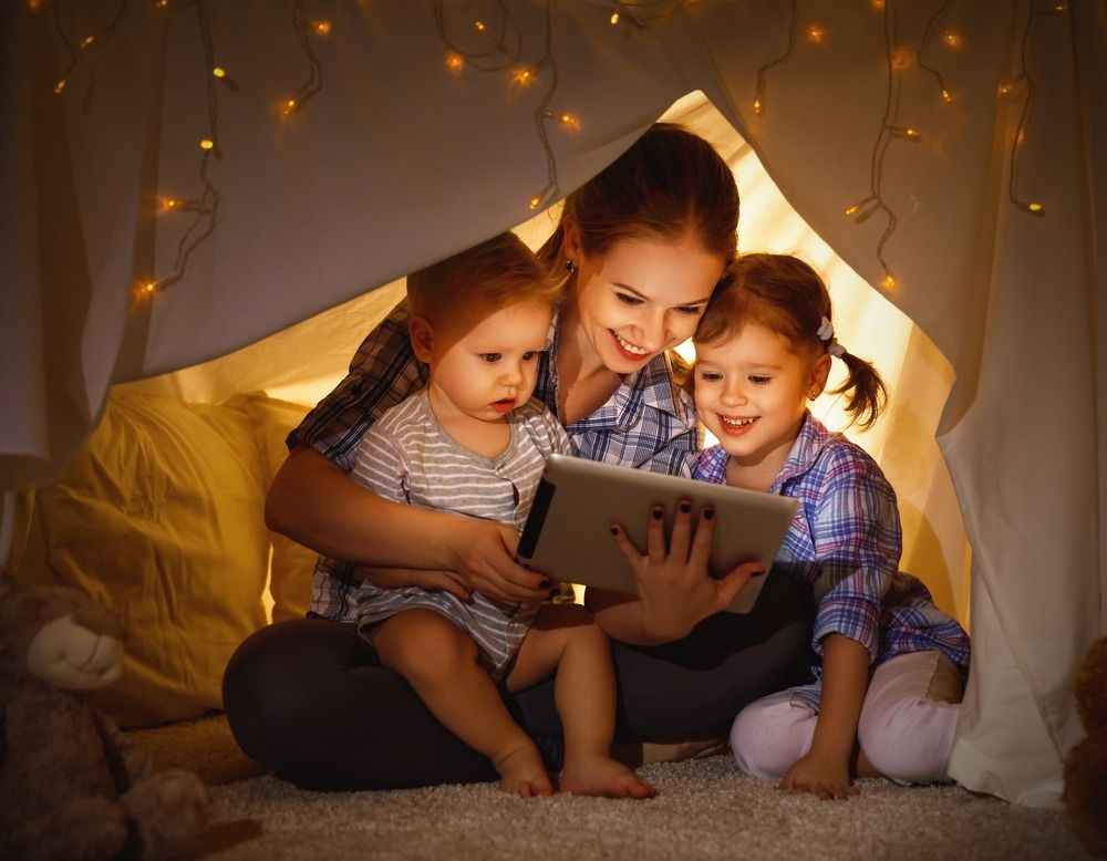 Mom and children reading in a hut
