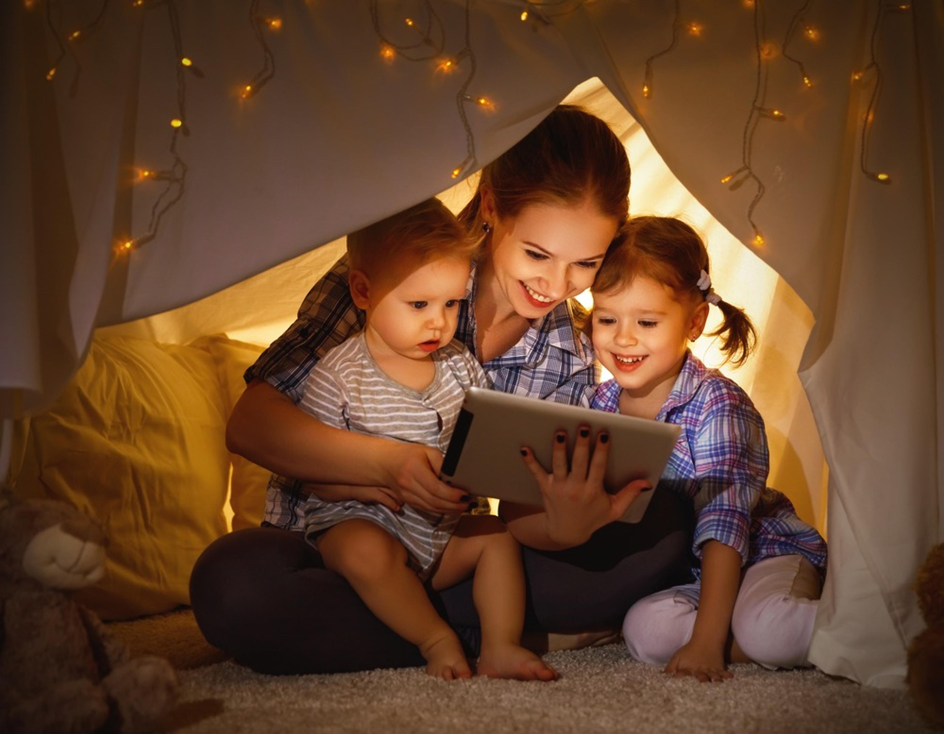 Mom and children reading in a hut