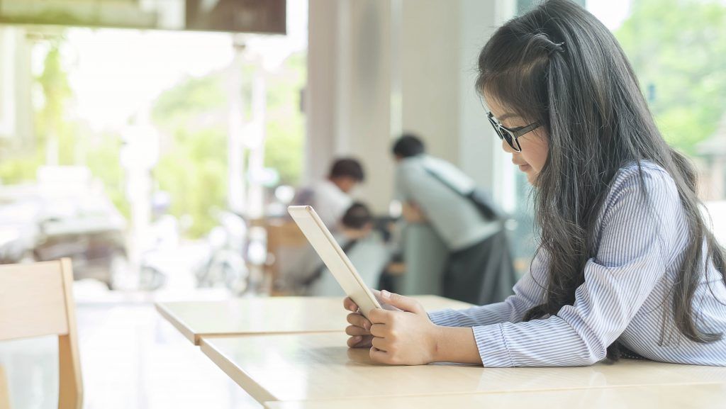 Girl reading a book in school