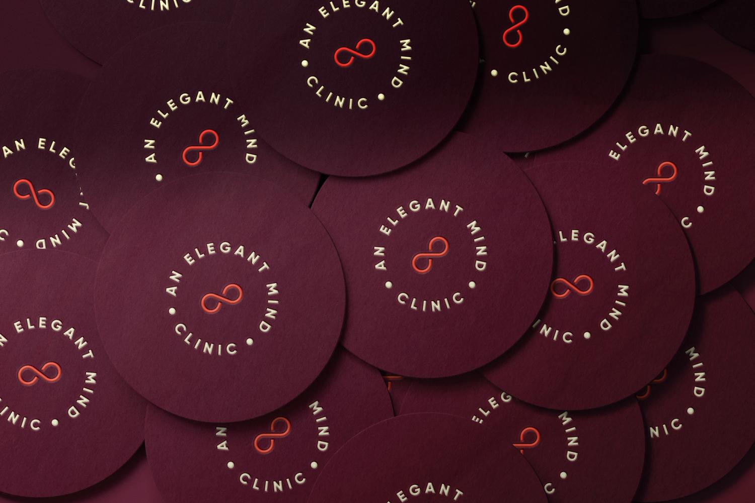 Minimalist logo for "An Elegant Mind Clinic" with an infinity symbol and elegant typography on burgundy circular background.