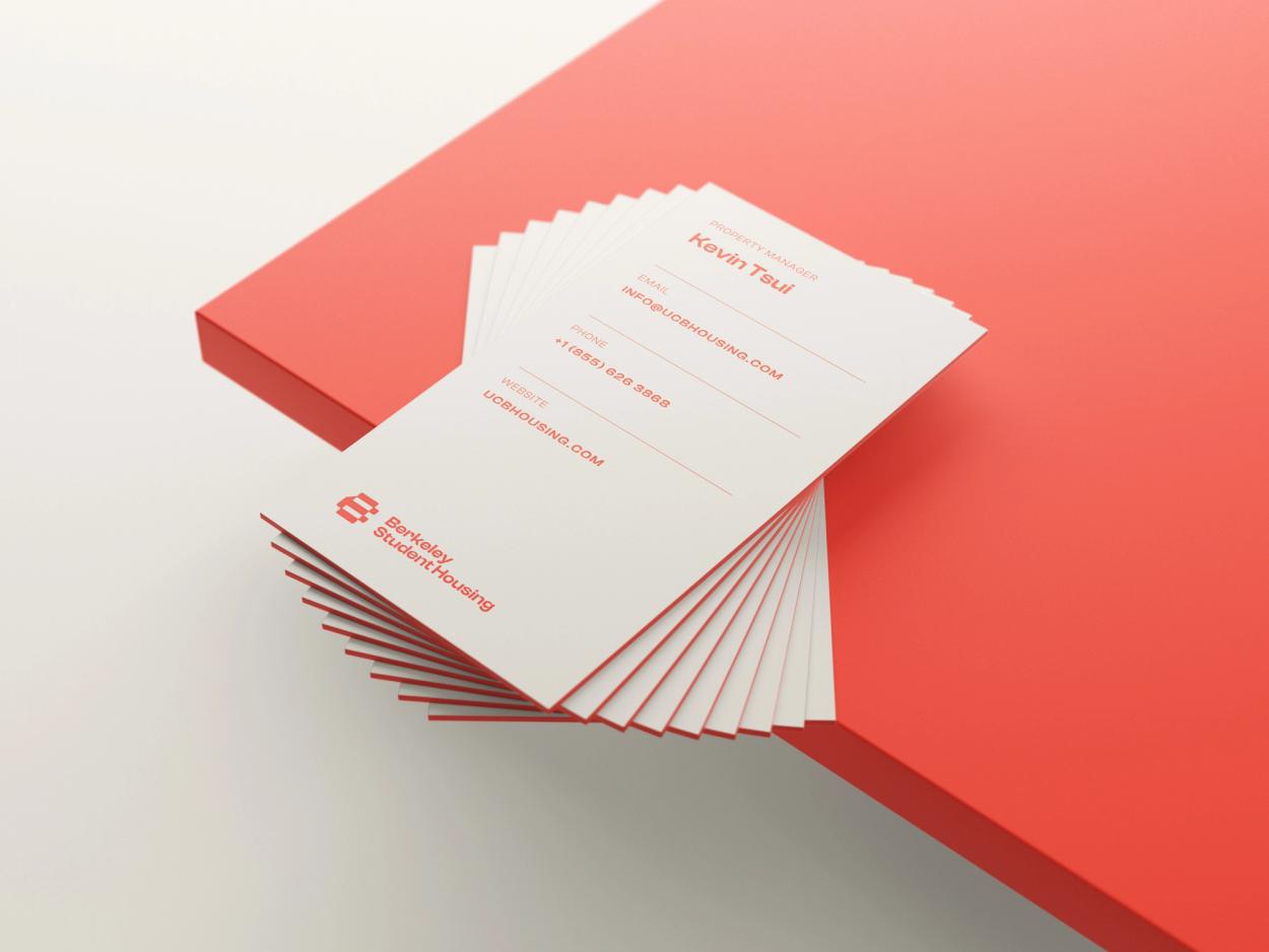 Minimalist business card mockup with clean white and red design.