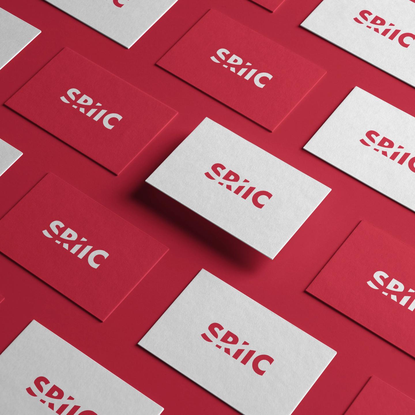 Collection of red and white business cards featuring the 'SRiiC' logo, arranged in a grid pattern on a red background.