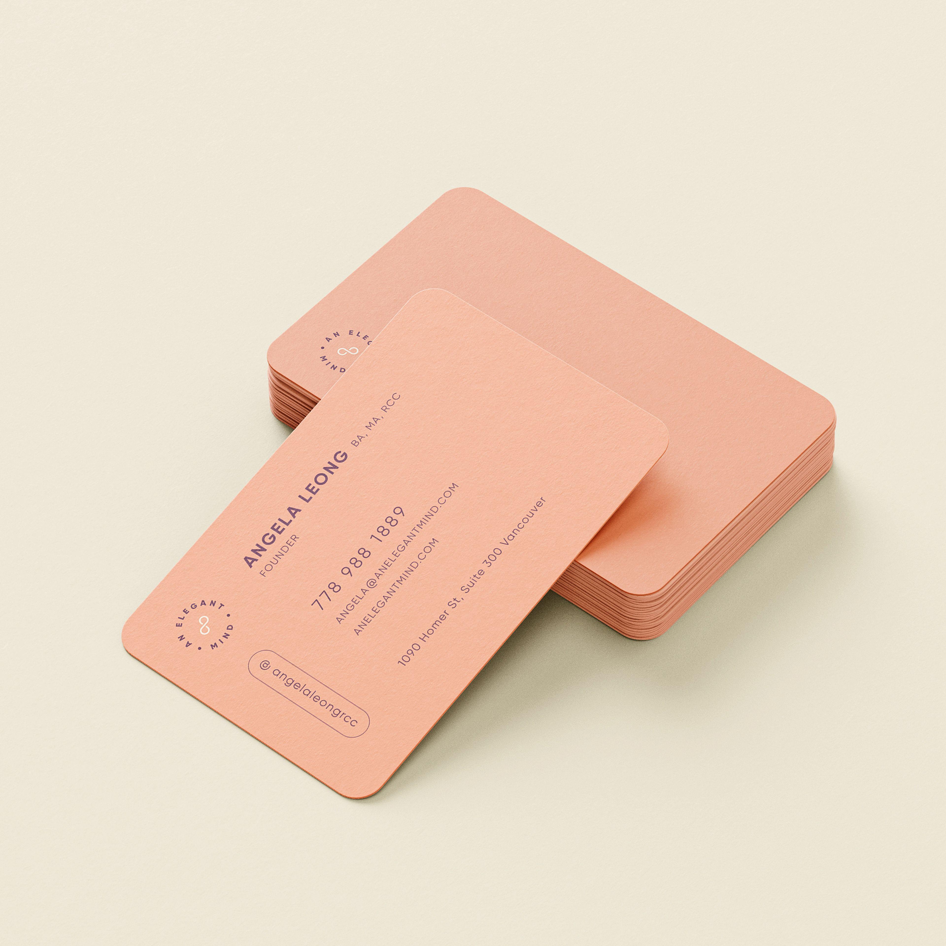 An Elegant Mind business cards in soft peach with rounded corners and minimalist typography.