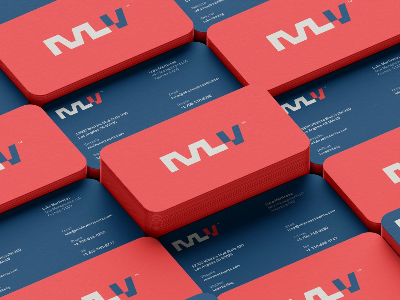 Stack of red and navy double-sided business cards for MLV Investments, featuring a bold monogram logo and rounded corners.