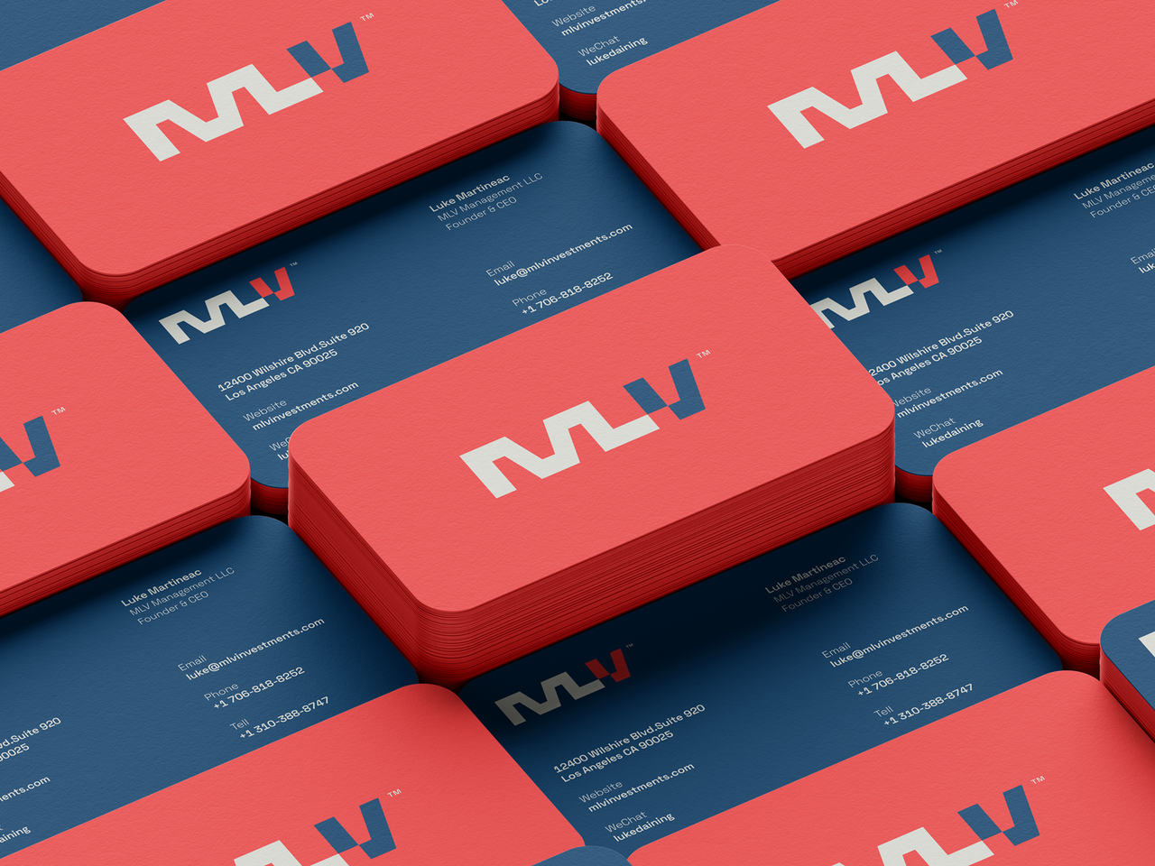 Stack of red and navy double-sided business cards for MLV Investments, featuring a bold monogram logo and rounded corners.