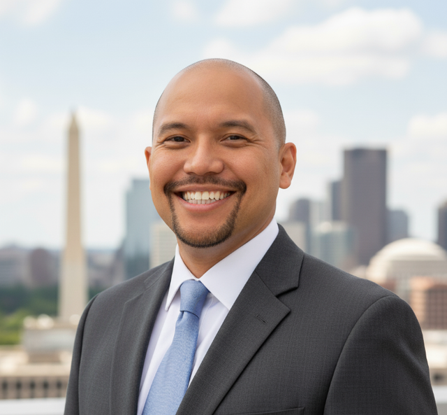 a man wearing a suit and smiling with a city backkgrouns.