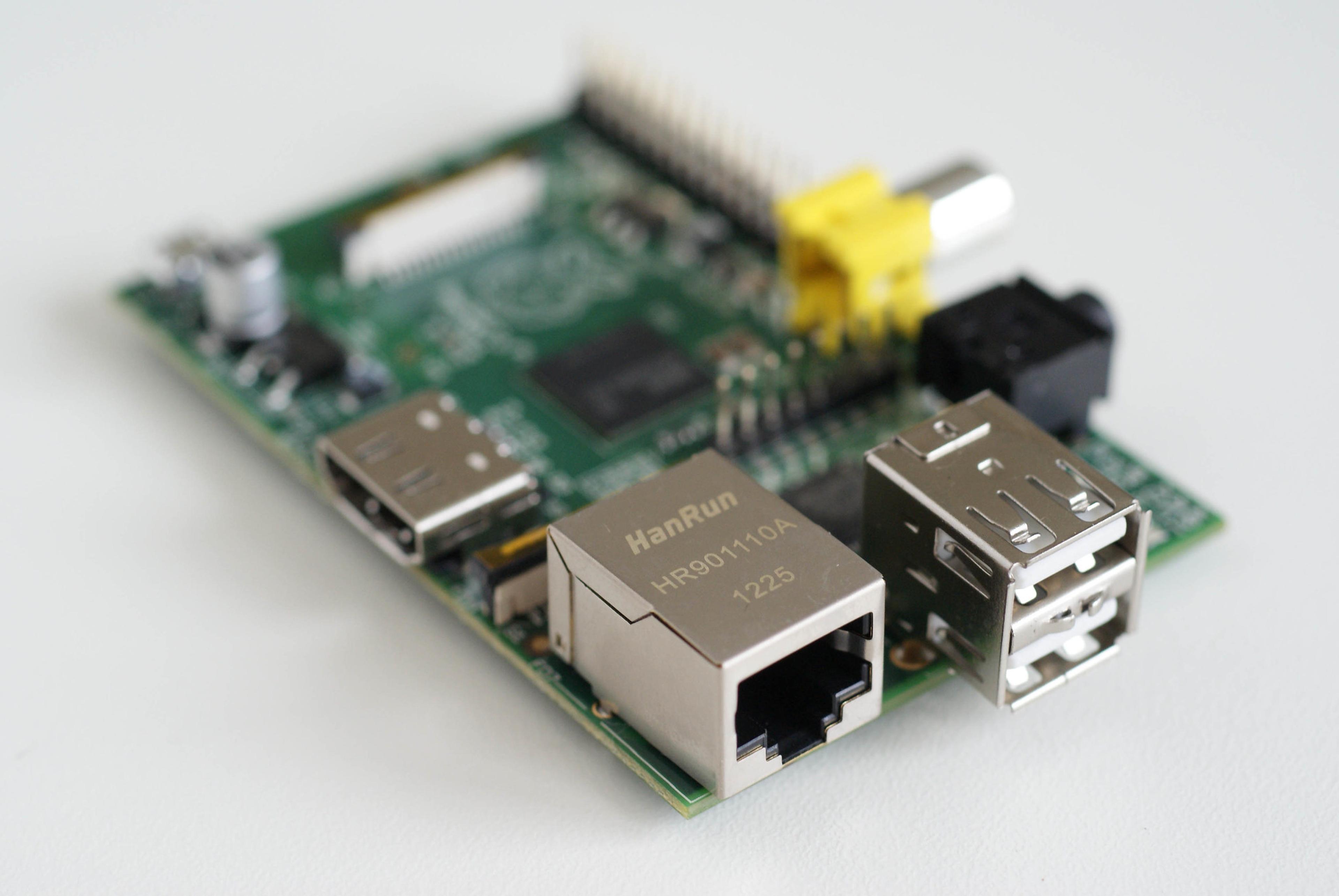 A Raspberry Pi, its ethernet port facing forward, against a white backdrop.
