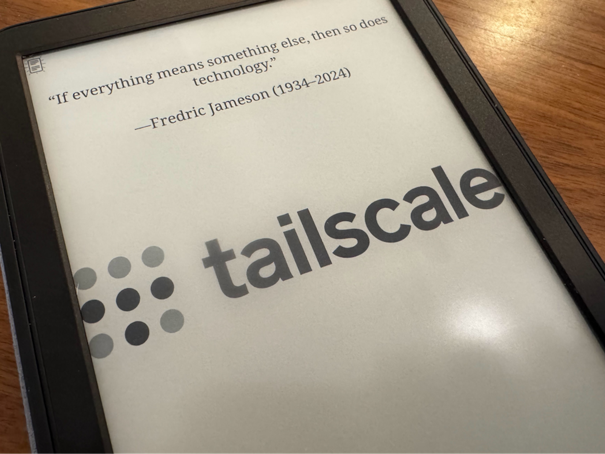 Close-up of a Kindle, with a Tailscale logo across its screen, and quote from Fredric Jameson on top: "If everything means something else, then so does technology."
