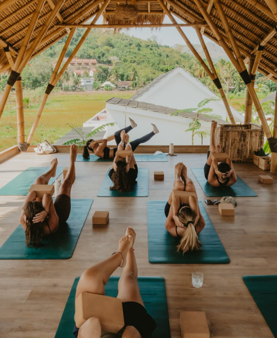 Yoga class inside the open-sided bamboo shala at Kairos Lombok