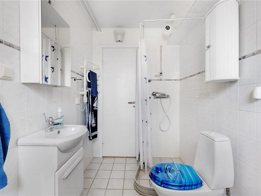 Vitt WC med blå toalettsits