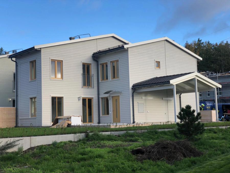 Tomten före arbetet, en tom gräsyta längs husets baksida