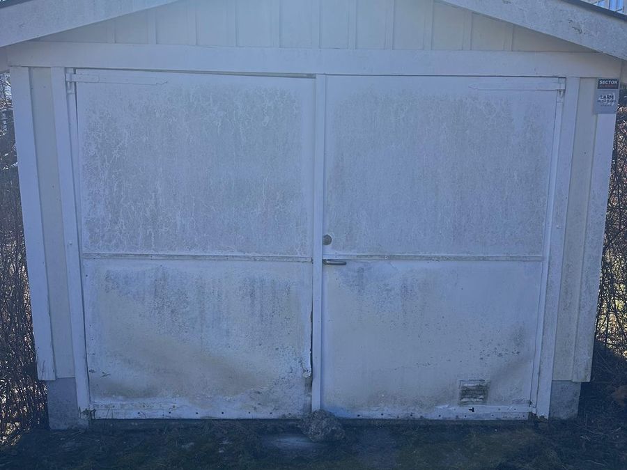 Gammal sliten garageport före renovering