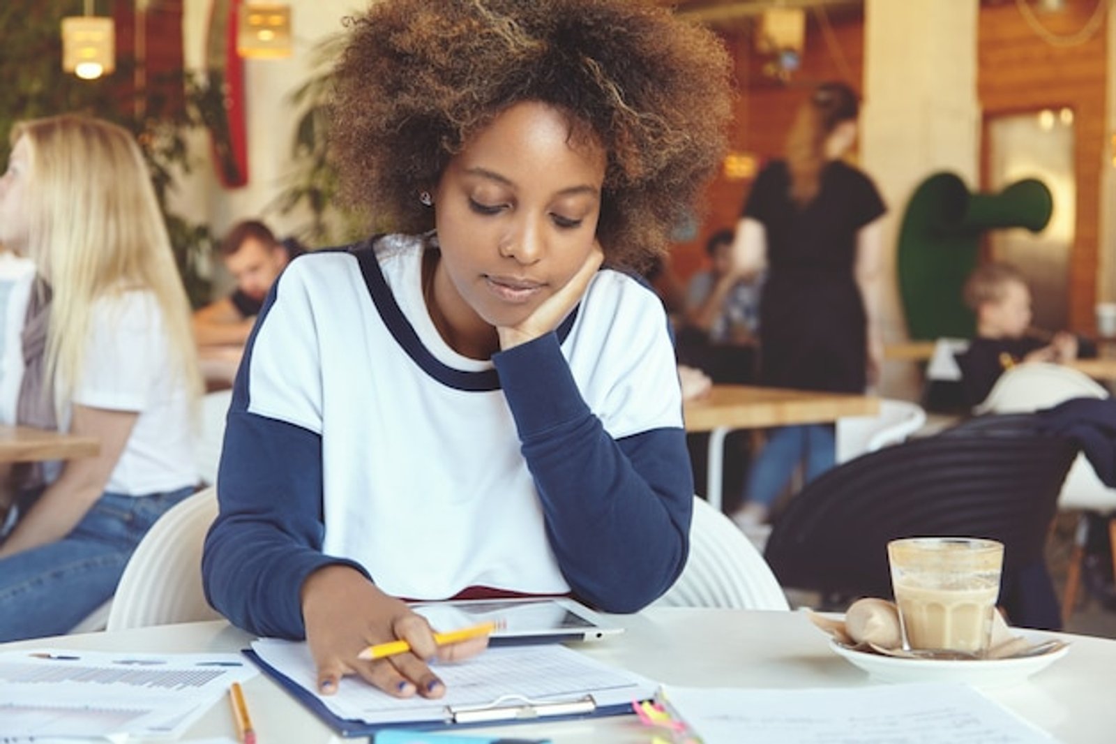 young student in cafe reading