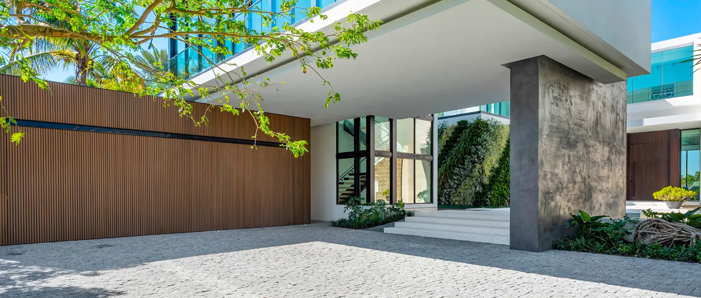 Covered porte-cochère driveway leading into a large open-air courtyard.