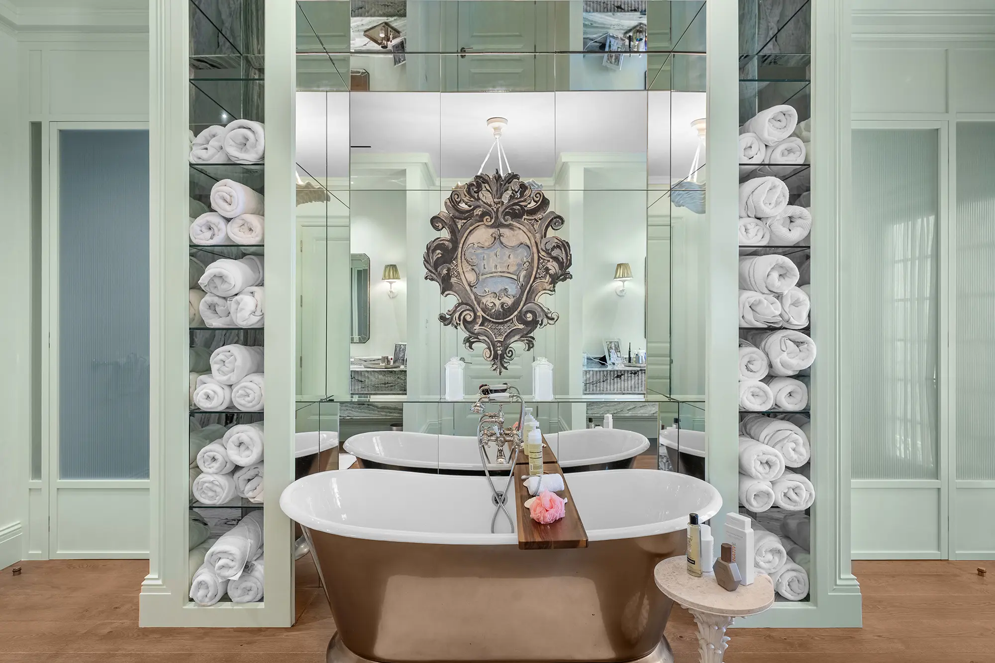 Luxury bathroom with freestanding tub, custom storage and mirrored details.