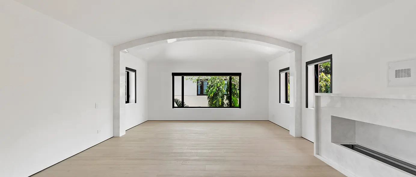 Gallery-style living room with curated art lighting and sleek marble accent details.