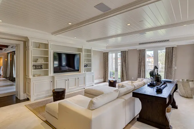 Crisp white living room featuring custom built-in shelving and clean architectural lines.