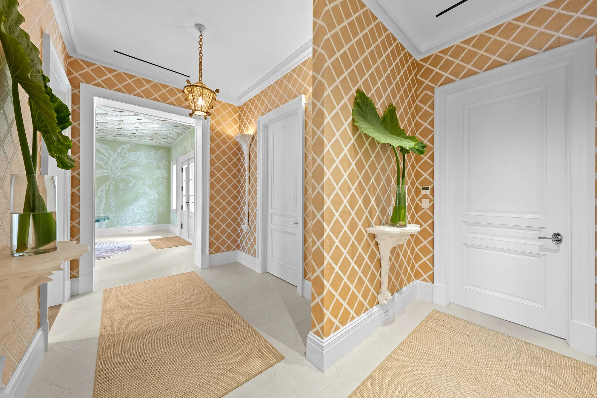 Luxury hallway with geometric wallcovering and custom architectural details.