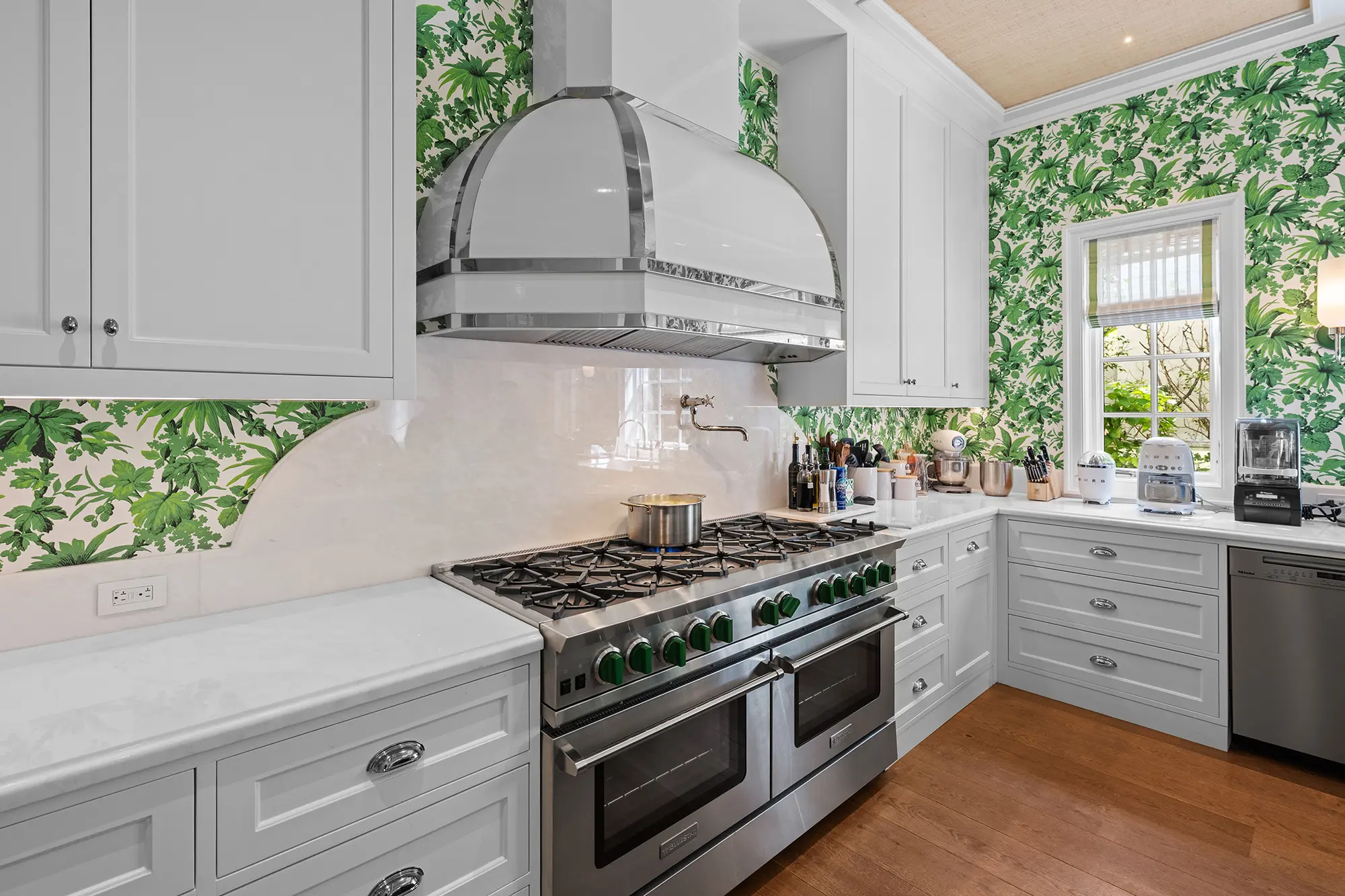 Luxury kitchen with custom cabinetry and botanical wallcovering.