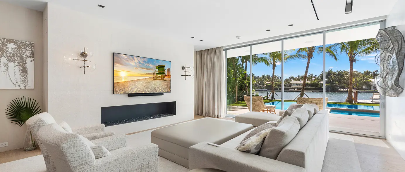 Spacious living room with sweeping views of the pool and patio.