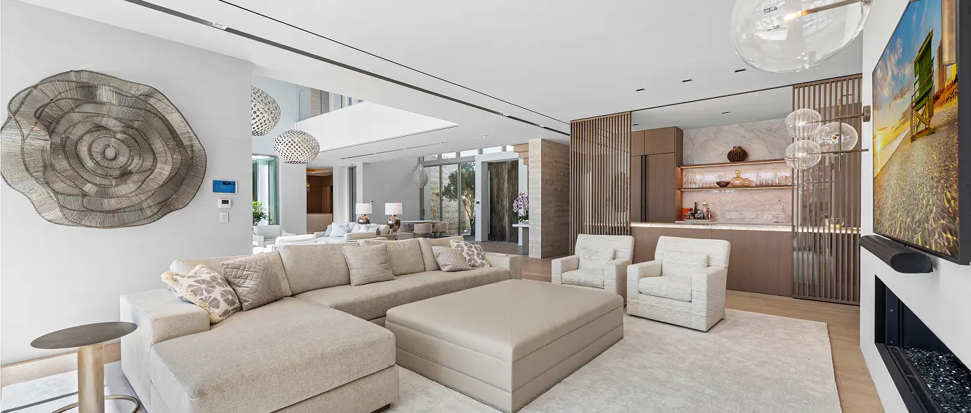 Large modern entertainment room with a full bar and open, flexible living space.