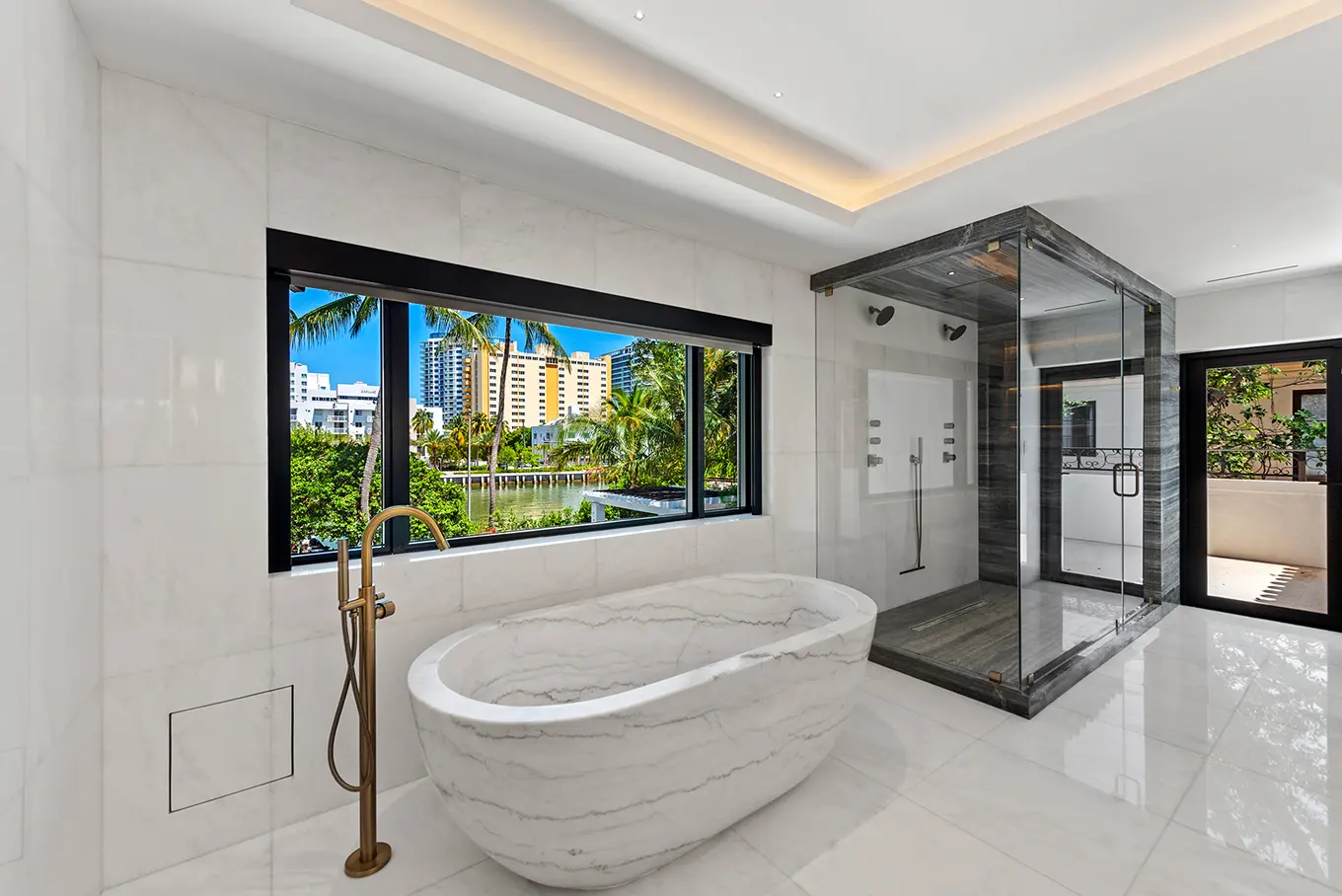 Spa-inspired master bathroom with freestanding marble tub, walk-in shower, and luxury fixtures