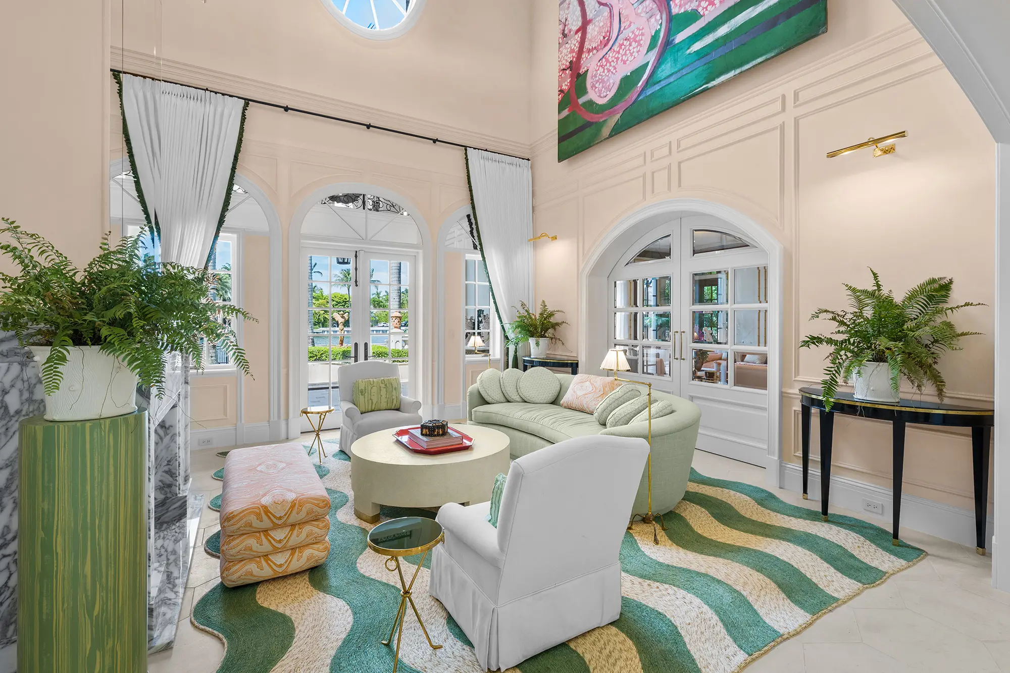 Luxury living room with custom furnishings and green accents.