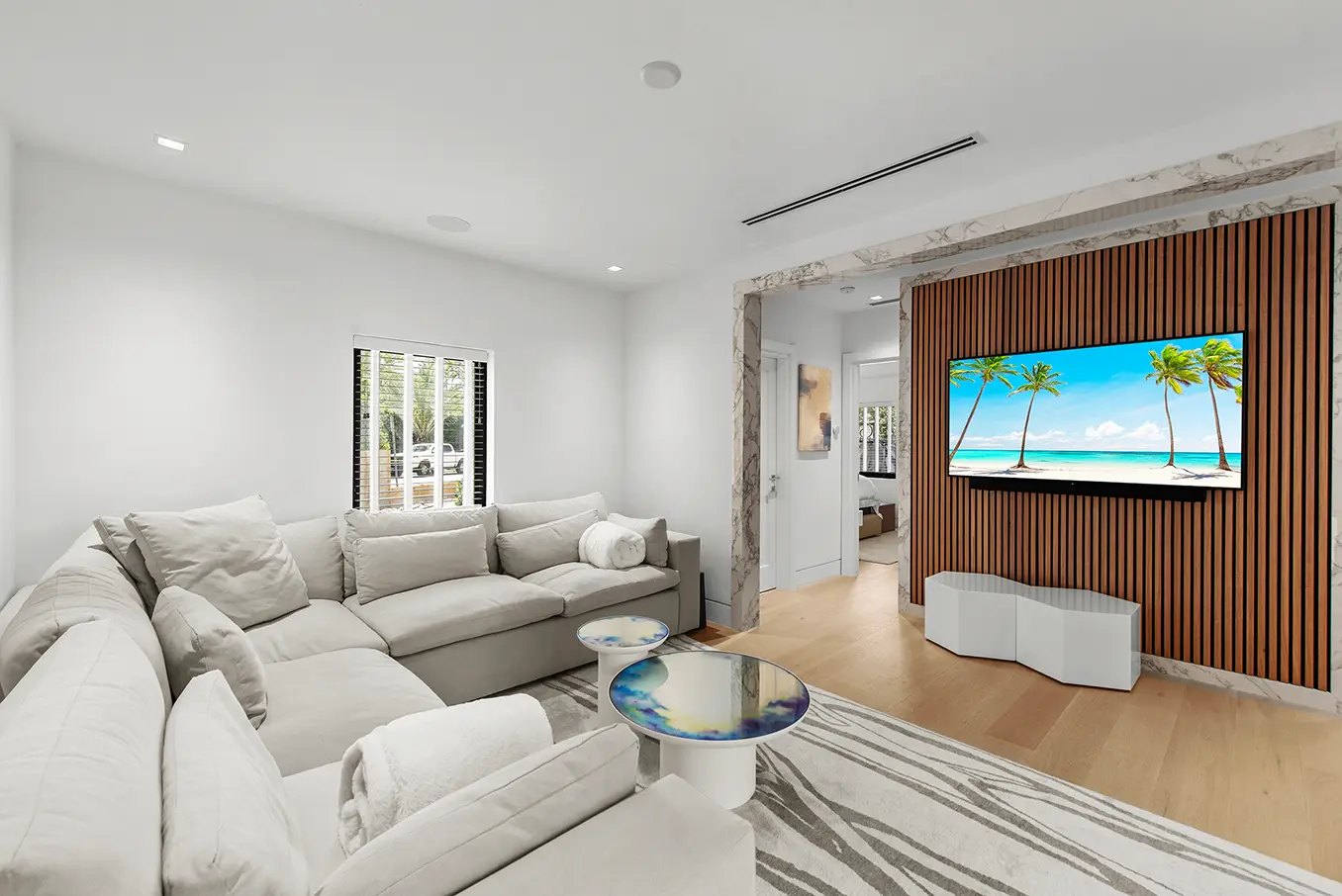 Sophisticated den featuring horizontal wood slat walls, marble accents, and modern built-in shelving