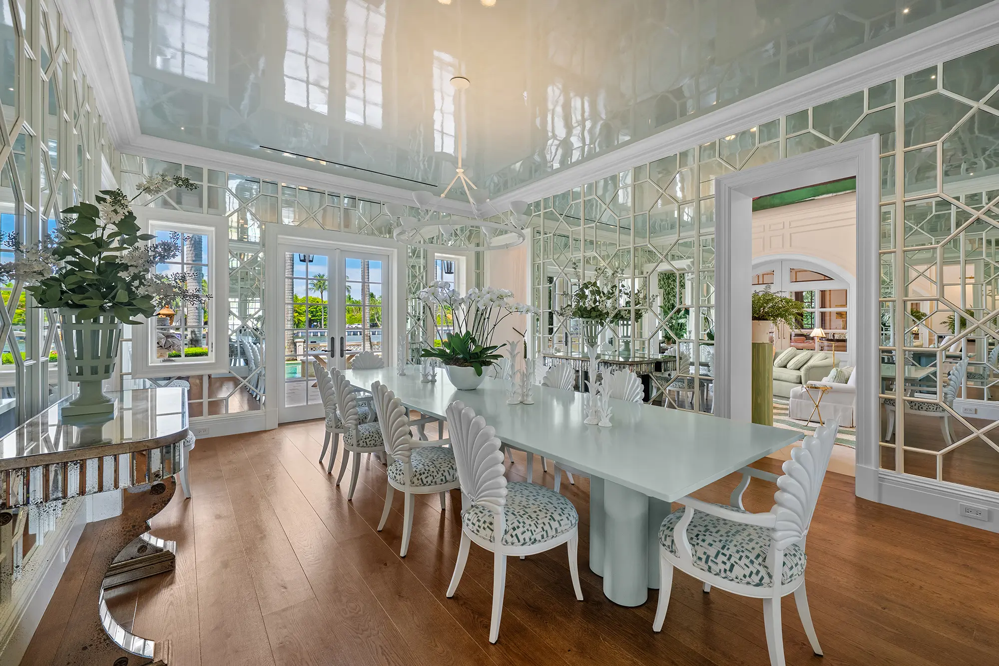 Luxury dining room with mirrored walls and custom furnishings.