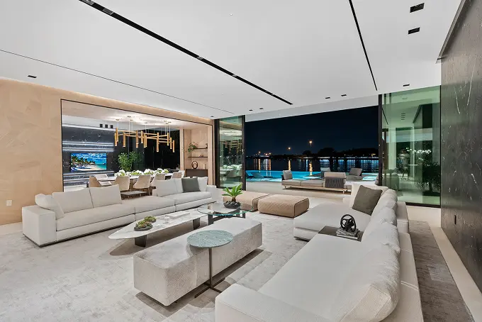 Open-plan dining and living room featuring tall ceilings and a seamless modern layout.