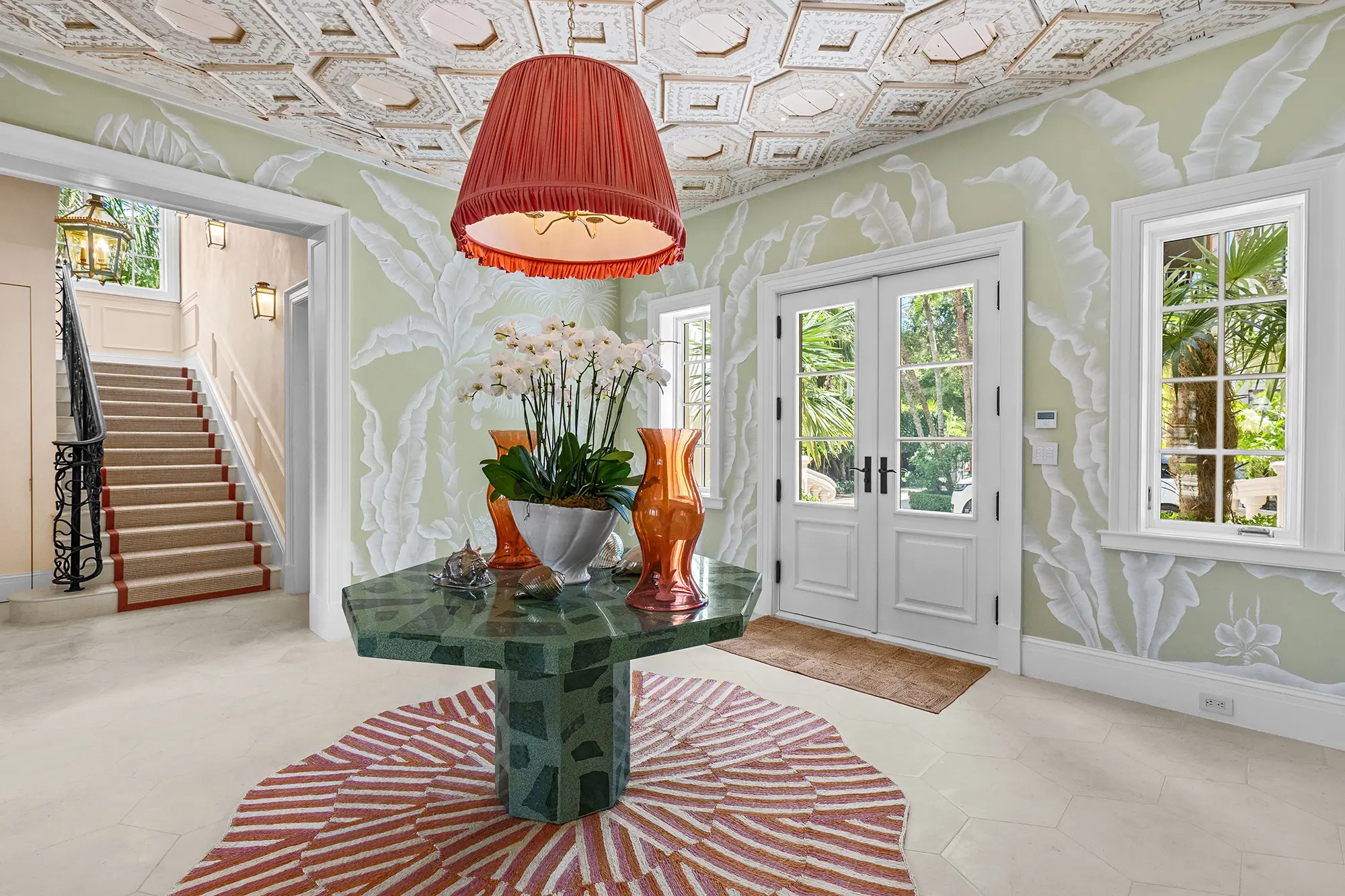 Luxury foyer with botanical wallcovering and custom details.
