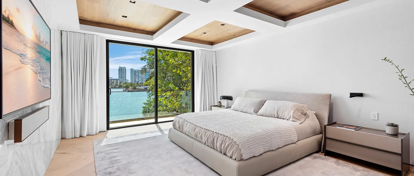 Large bedroom featuring wood inlay ceilings and sweeping views overlooking the bay.