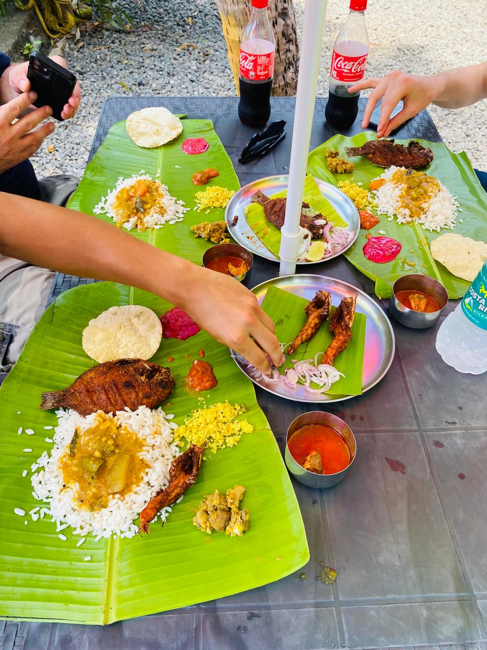 Traditional Kerala lunch on a banana leaf on an Alleppey houseboat.