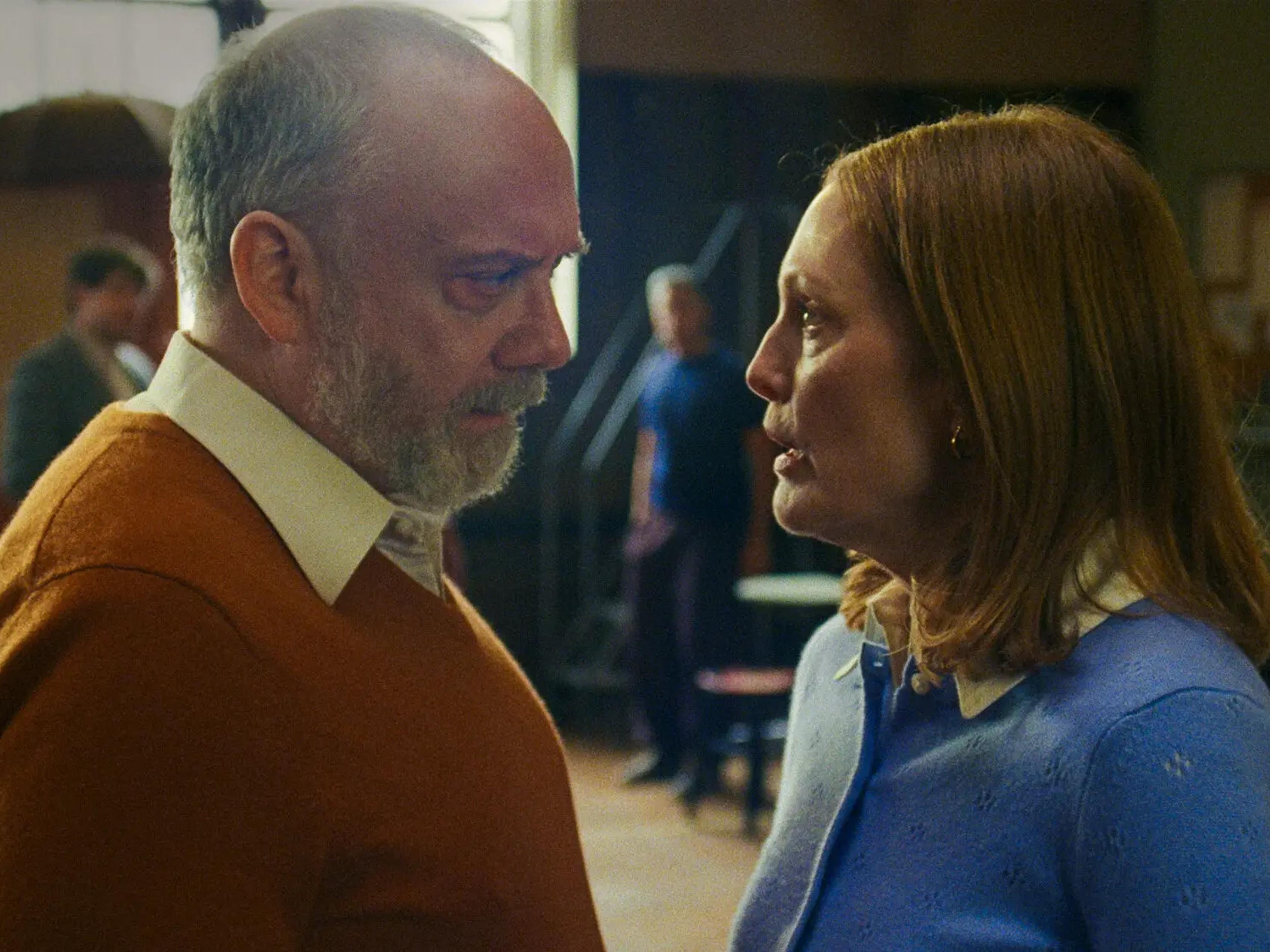 Paul Giamatti and Julianne Moore talking, blurred theatrical background