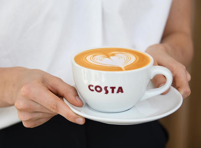 A person holding a cup of coffee