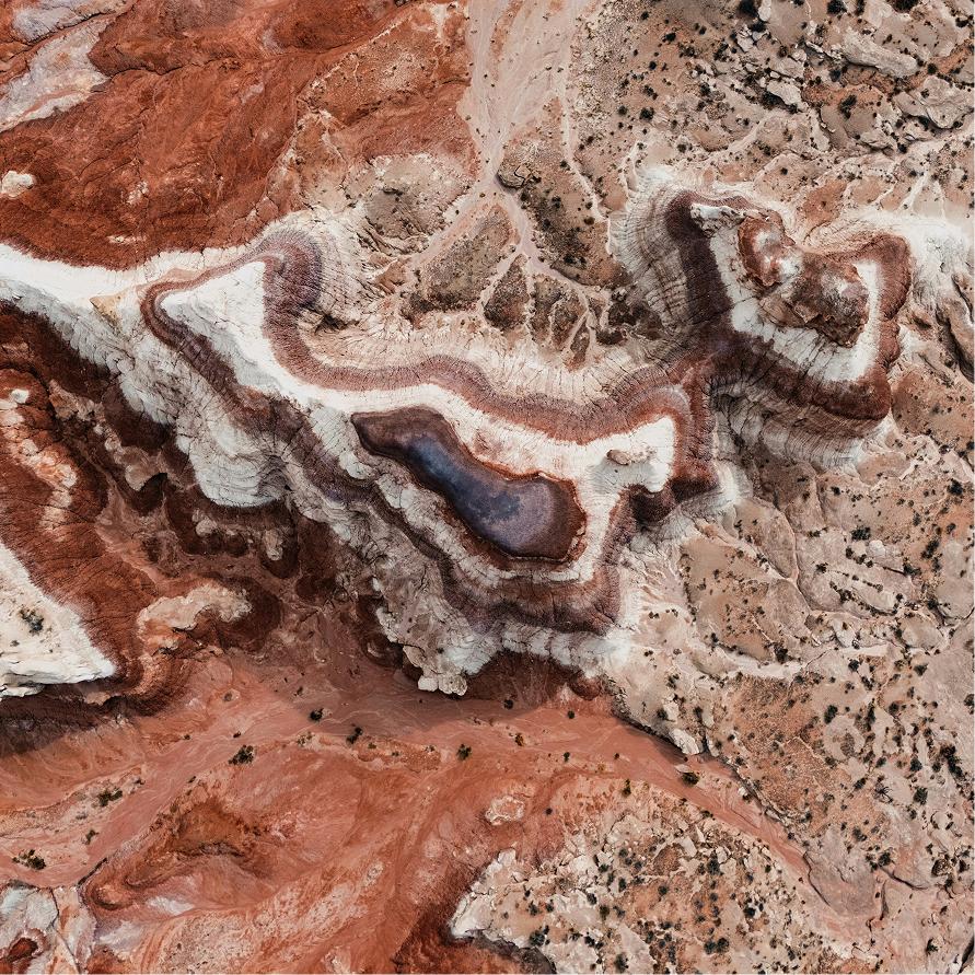 An aerial view of layered red rock canyon country