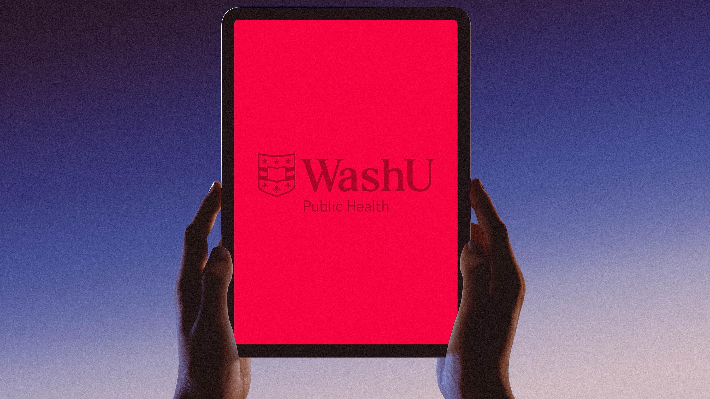 Hands holding an iPad that is displaying the WashU logo