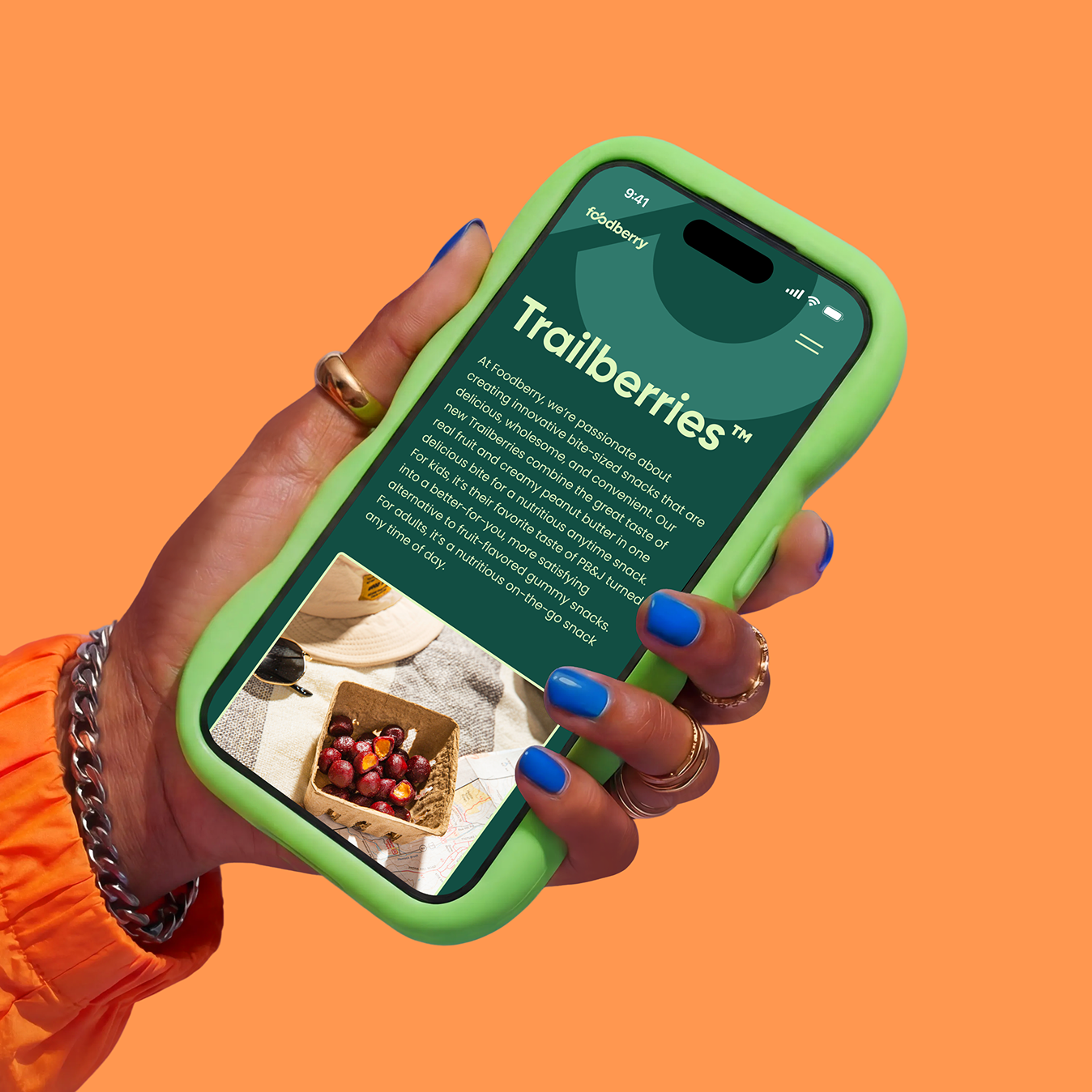 Hand holding a phone with Trailberries page shown on screen