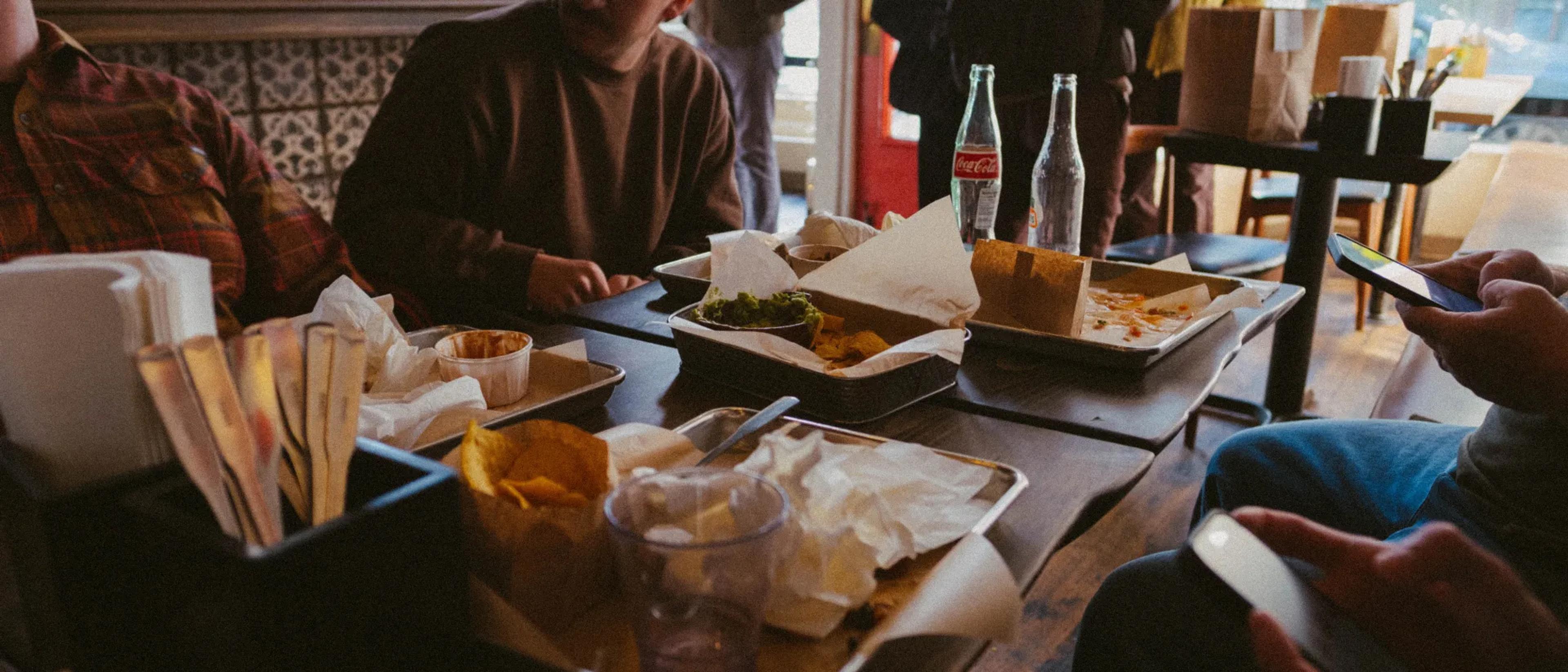 Team members gather around a restaurant table after sharing a casual lunch.