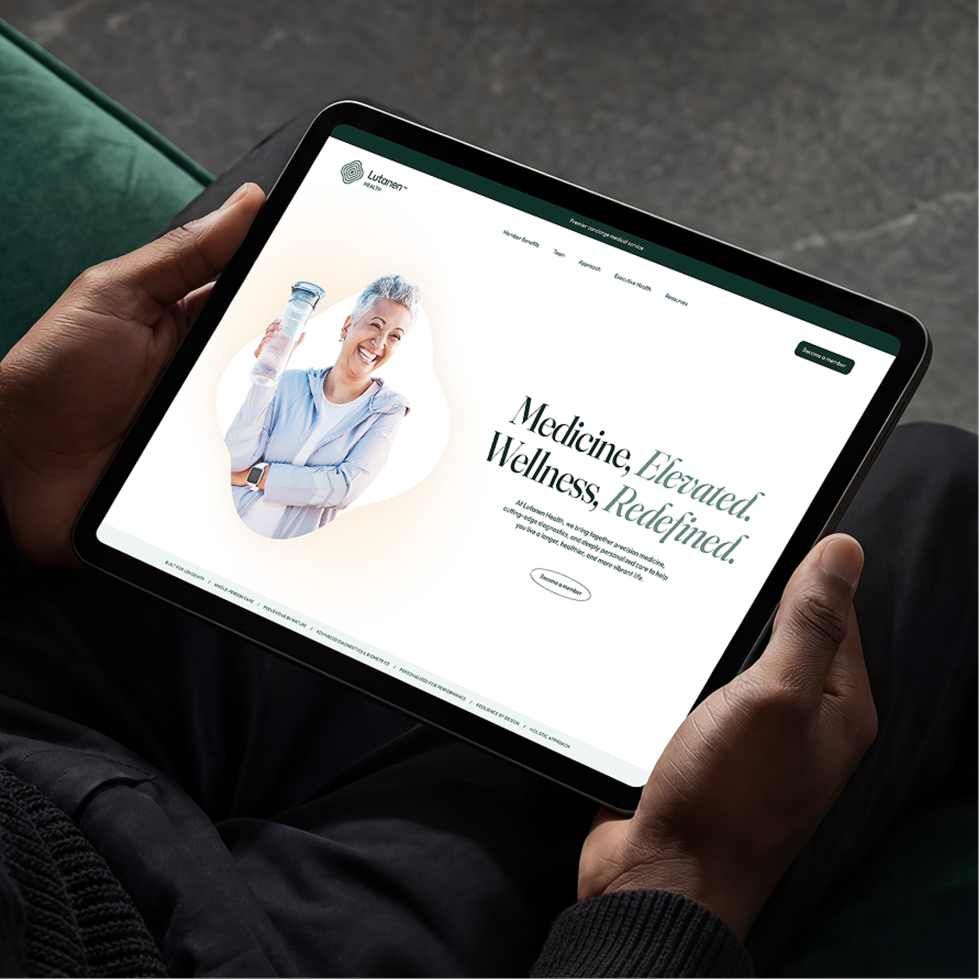 Hands holding a tablet showing the Lutanen Health site