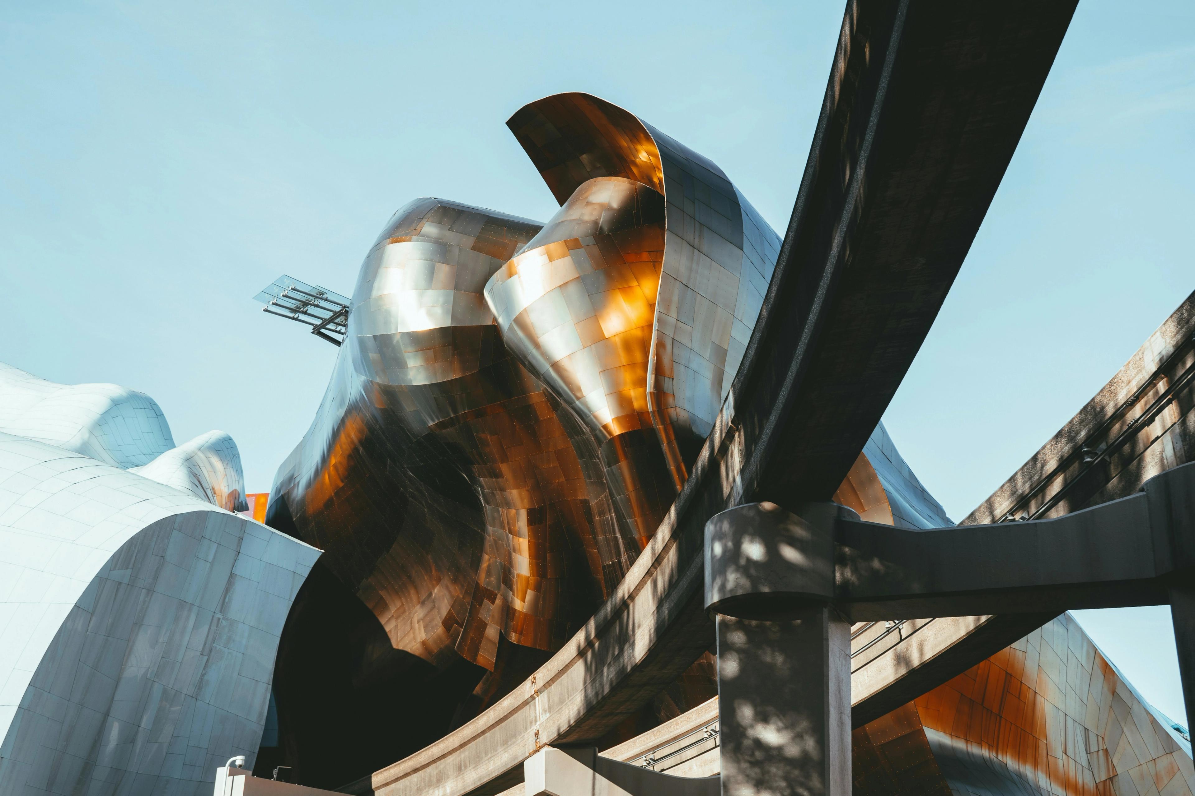 The metallic facade of Seattle's Museum of Pop Culture, with the monorail track curving past