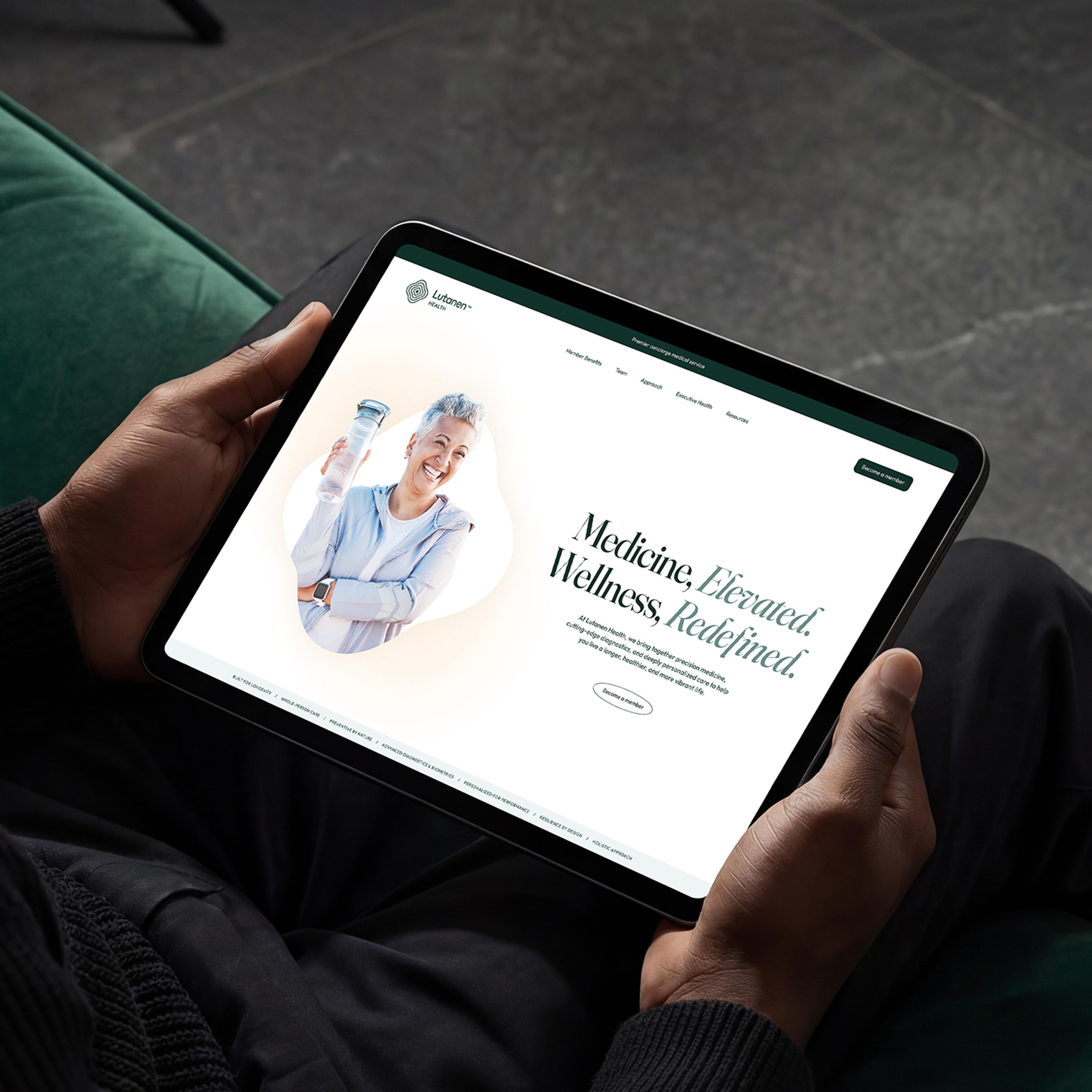 Person's hands holding a tablet showing the Lutanen website