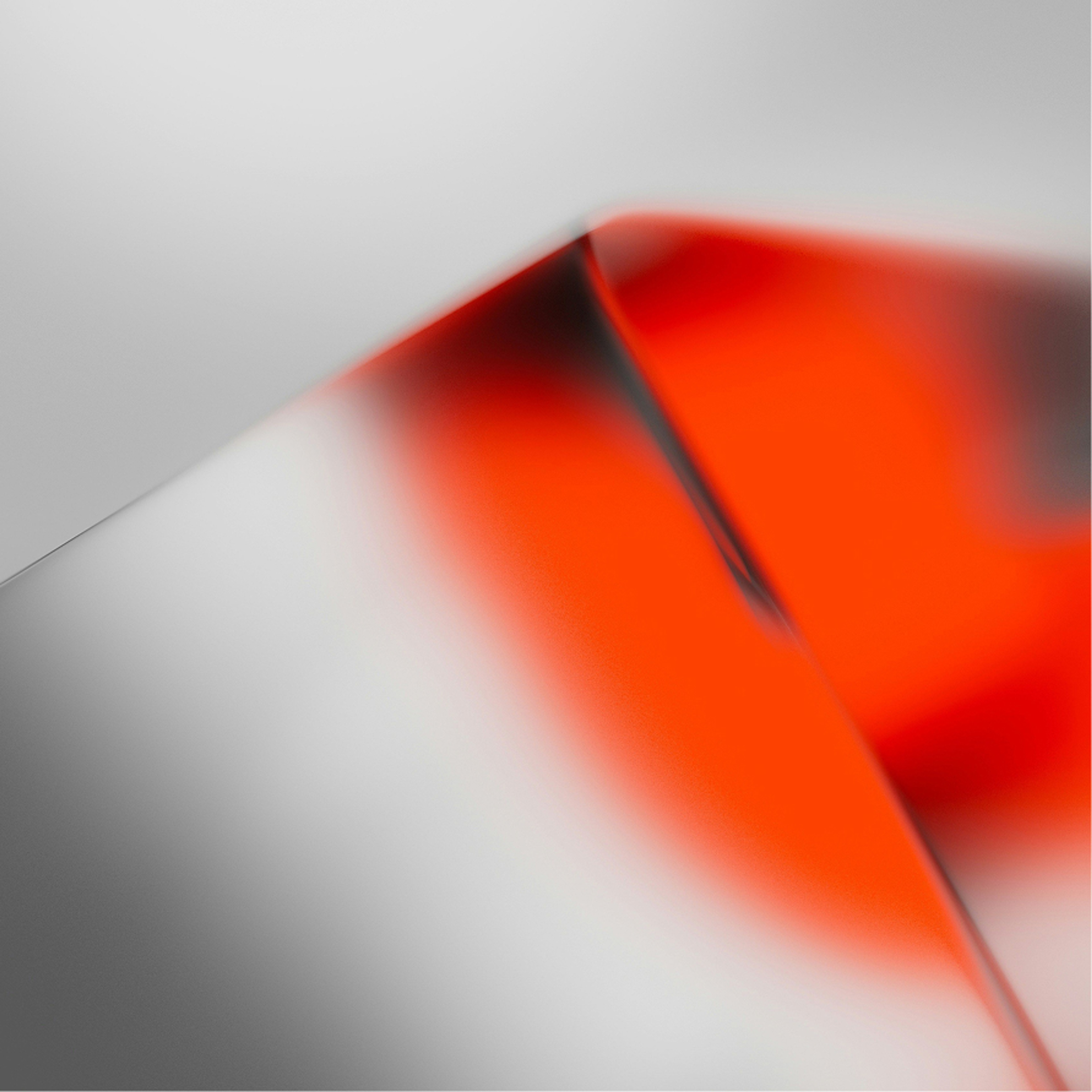 A blurred fold of red and grey light
