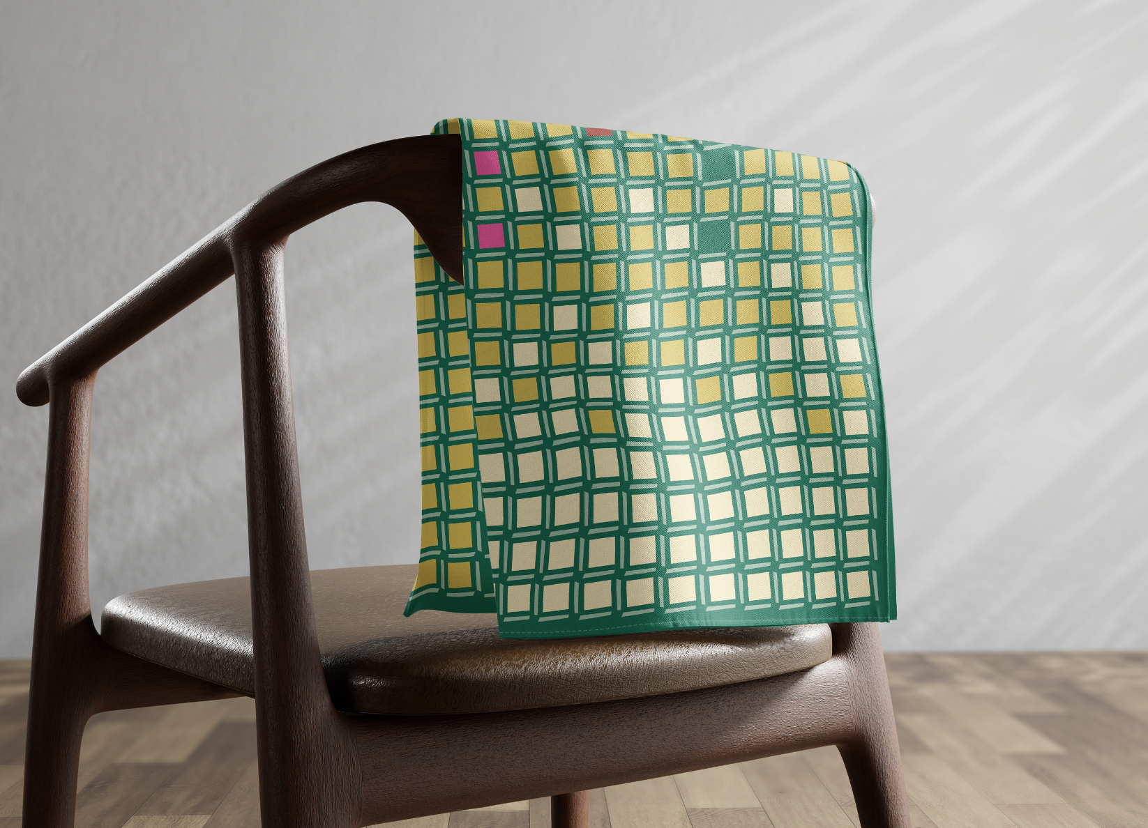 Green and yellow Peranakan pattern scarf draped over a chair
